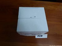 White sealed box from top view for napkin bands.