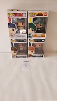Set of four Funko Pops in original boxes stacked two by two: John Cena, Deku, Harry Potter, Ron Weasley.