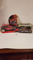 Photo showing all three toys together: Harley Davidson bike, Ford truck, Gi Joe vehicle set in packaging