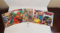 Six comic books laid out on a surface, showing cover art and titles, part of the lot.