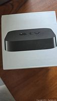 Apple TV box front showing device image