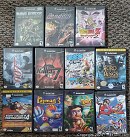 Twelve (actually eleven) GameCube cases arranged on carpet in 3-4-4 layout