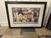 Full view of the framed print featuring a winter ice skating scene with a large Victorian house and gazebo.