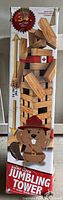 Photo of boxed jumbling tower showing box artwork, size details (34 inches tall), 51 pieces, and design featuring a cartoon beaver with a hat.