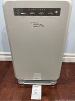 Front view of the air purifier showing the control panel with buttons labeled power, mode, speed, ion and the brand and series line text.