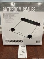 Box of Noctex bathroom scale with product information and features printed on front showing tempered glass platform, LCD display, and capacity up to 180kg.