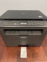 Front view of a black Brother DCP-L2520DW printer with control panel and display screen visible.