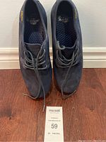 Top-down view of the pair of black suede-like Dr. Martens shoes showing laces and interior lining.