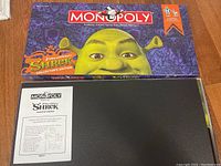 Monopoly Shrek Collector's Edition game box partially opened showing game board inside.