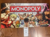 Box cover showing Monopoly title with Street Fighter characters in dynamic poses