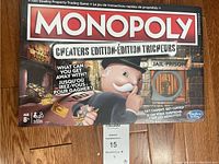 Image of Monopoly Cheaters Edition game box front showing the title, Mr. Monopoly character, and jail/prison theme.