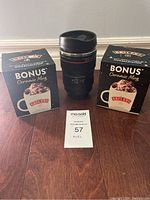 Front view of the Canon lens mug and two Baileys ceramic mug boxes with lot ticket