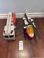 Fire truck and helicopter side by side on floor