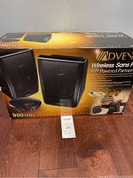 Box with image and branding of Advent Wireless Speakers showing two speakers and wireless base station.