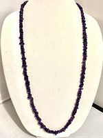 Full view of the 38-inch long purple amethyst chip necklace on a white display bust.