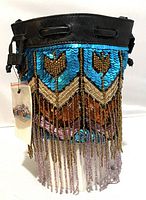 Front view of small bucket-style purse with black leather top and colorful sequins and beaded fringe below. Original tags attached.