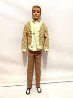Full front view of Ken doll standing upright showing clothing and shoes.