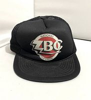 Front view of black trucker cap with ZBC National Television logo patch