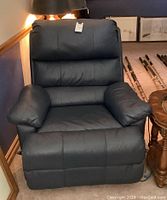 Front view of blue electric recliner chair upholstery and cushions