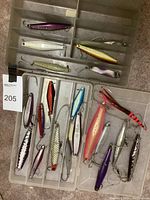 Two plastic tackle trays side by side showing total lot of 18 metal jigs in various compartments