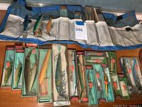 Lures arranged in a roll and original boxes, showing variety in shape and colors, most Rapala brand