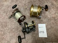 Three reels arranged on carpet with lot card