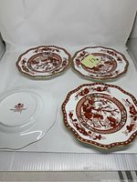 Four Coalport Indian Tree Coral pattern plates, two facing up showing the front design, two stacked with one backside showing the Coalport mark