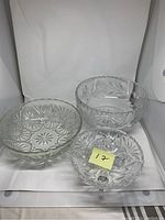 Three clear crystal bowls arranged together, showing all items in the lot