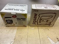 Two boxes side by side: one labeled 'Portable 150 Watts Halogen Work Light' and the other labeled 'Jigsaw 7515' with a line drawing of a jigsaw.