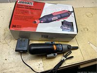 Black Jobmate rotary tool with power cord, speed switch, and original product box showing 36-piece kit.