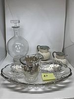 Lot of antique glassware and ceramics showing decanter, jugs, tray, and creamer