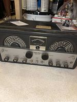 Front view of vintage Hallicrafters SX-99 tube radio receiver showing dual tuning dials, meters, and multiple knobs on faceplate.