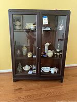 Front view of mahogany Ardmore Bookcase with decorative items inside