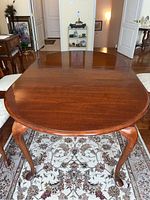 Front view of table with cherry finish top and Queen Anne style cabriole legs