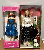Full view of both Barbie dolls in their original boxes, showing the 1998 Kay-Bee Barbie in blue dress and 2003 Talk of the Town Barbie with polka dot skirt and pet poodle.