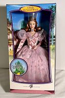 Front view of Glinda the Good Witch Barbie doll in original box showing pink gown and packaging.