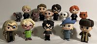 Front view of all 12 Harry Potter Funko Pop vinyl figures displayed in two rows showing each character and creature.