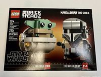 Front of factory sealed Lego Star Wars Brickheadz set box, showing assembled figures of The Child and The Mandalorian, with piece count and set number.