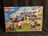 Front of the Lego City Police Mobile Command Truck box showing set number, minifigures, and included vehicles.