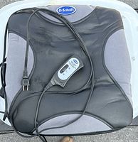 Black and gray Dr. Scholl's back massager pad with attached remote and power cord.