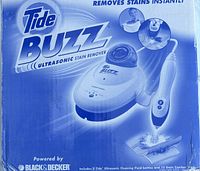 Photo of the Tide Buzz Ultrasonic Stain Remover box showing the device image and branding, highlighting instant stain removal and Black & Decker power.