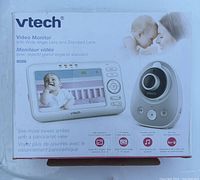Front of the box showing product name, brand, images of baby and mother, image of monitor screen and camera.
