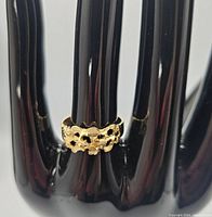 Ring displayed on a black hand stand showing overall band design