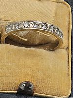 Ring inside velvet jewelry box, close view of diamonds and channel setting