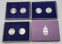 Four coin sets shown including coins with portraits and buildings and the original purple box with Hamilton 150th Birthday 1996 label.