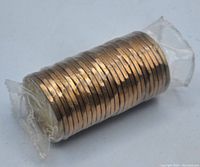 Side view of the sealed roll showing the stacked coins wrapped in plastic.