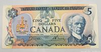 Front of 1979 Canadian five dollar note showing Sir Wilfrid Laurier and coat of arms.