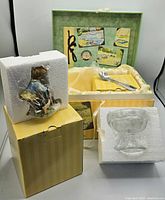 Original unopened Enesco Cherished Teddies figurine box with styrofoam cushioning, showing the figurine wrapped in plastic and additional clear plastic protective piece.