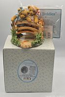 Figurine on original box with certificate in background