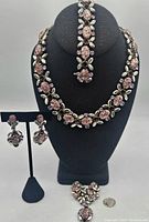 Full set displayed on black bust and stand